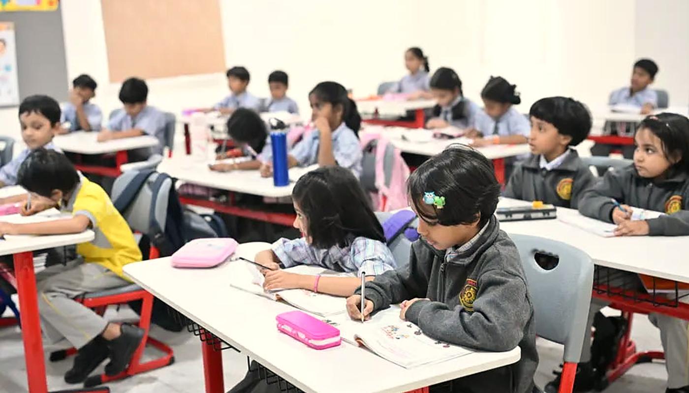 Students focused on their work at desks in a bright classroom