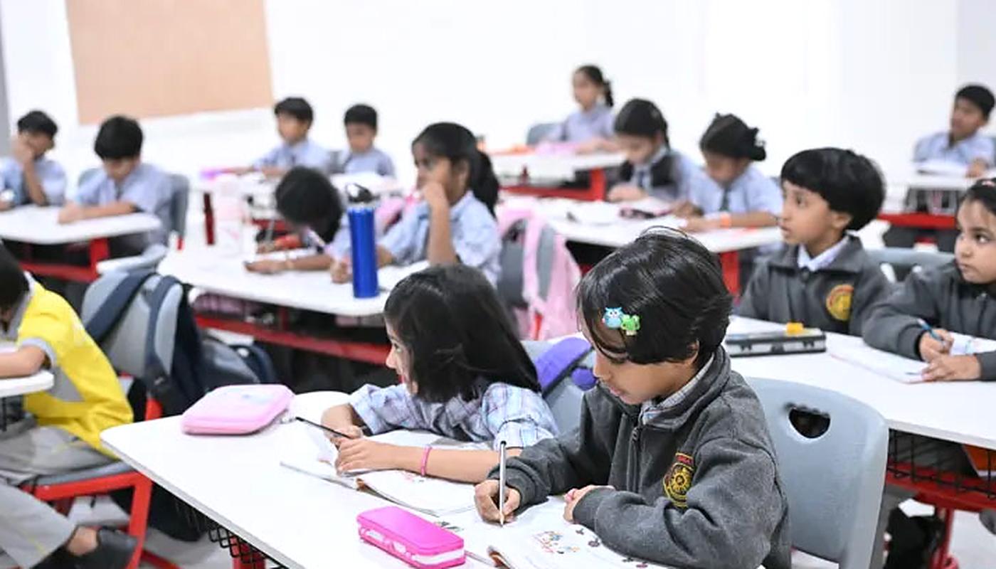 Building a reading habit Children reading and writing at their desks in a primary classroom