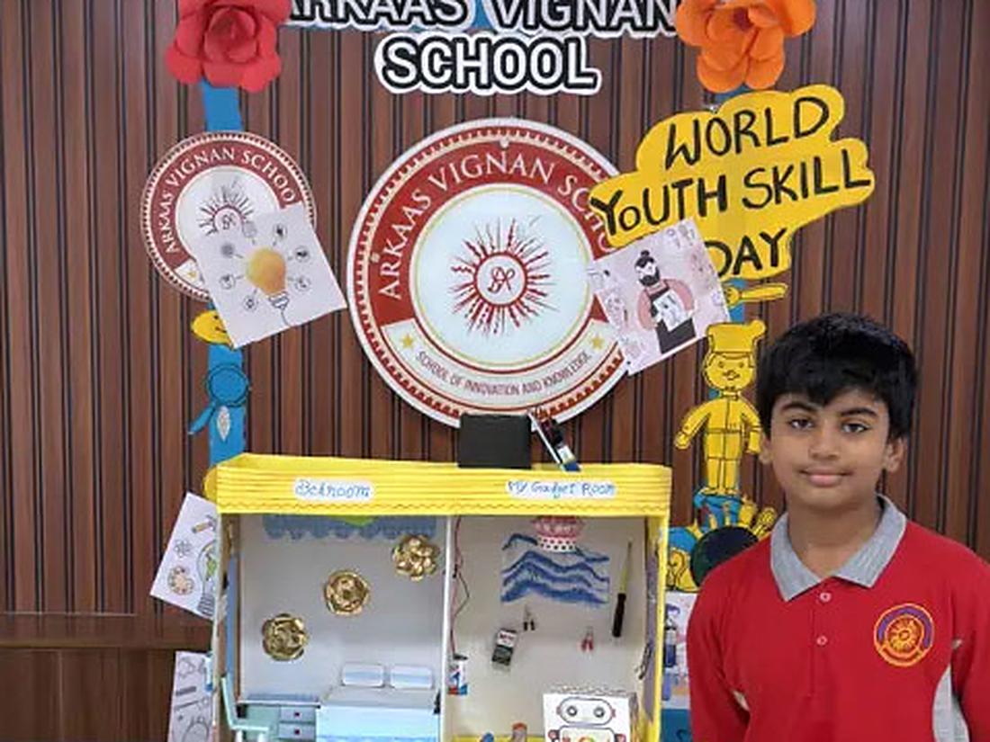 Student with a colourful handmade craft project