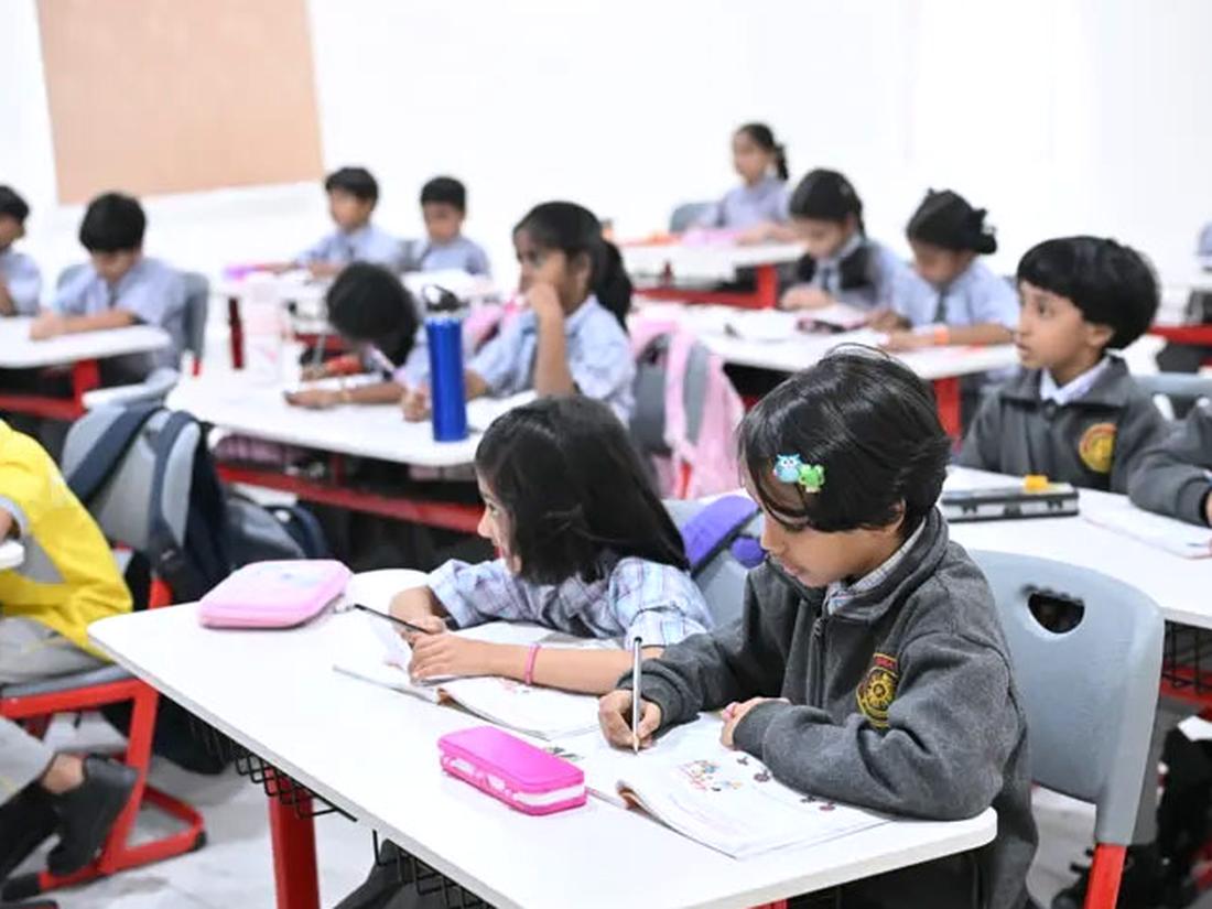 Organised classroom with rows of student desks and display boards