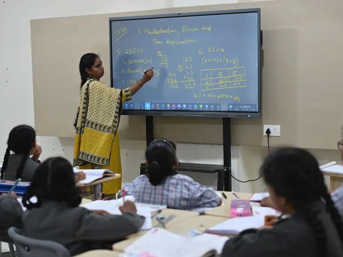 Teacher supporting a group of children during an activity
