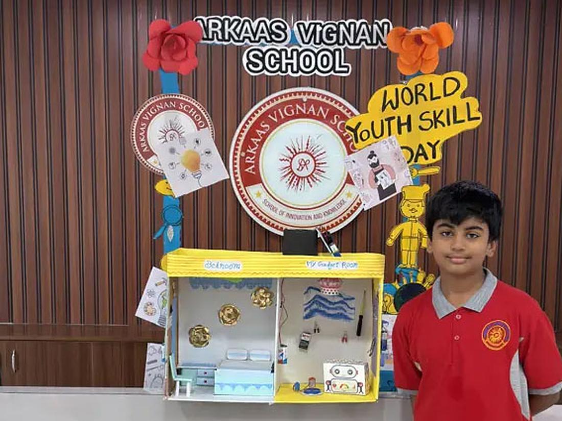 Student standing proudly beside a project at a skills day